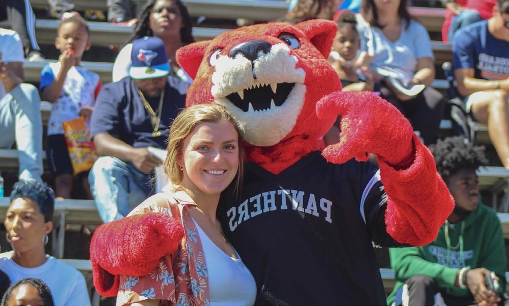 A female student poses with Pouncer